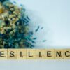 a scrabble type block spelling the word resilince